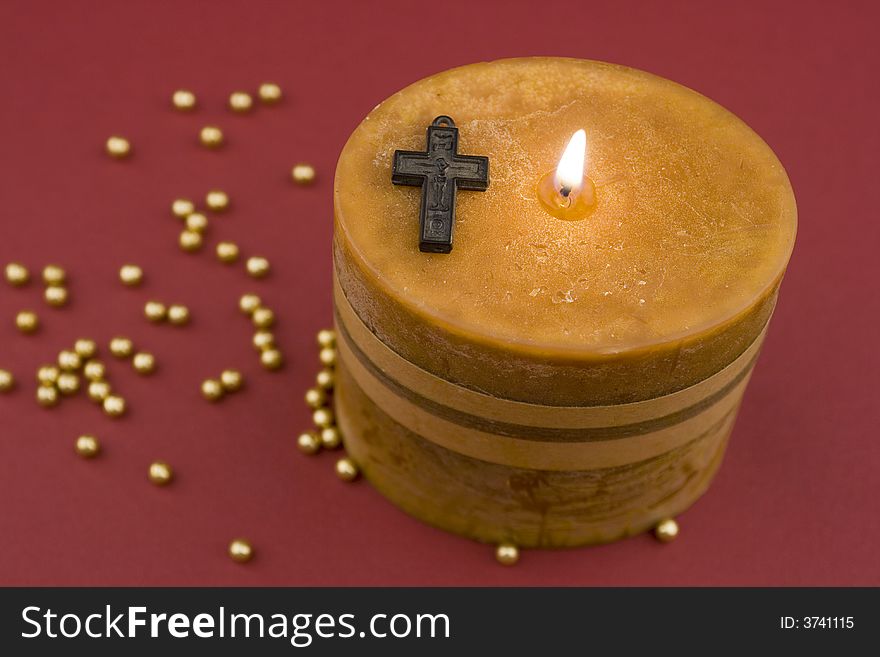 Cross and candle on background