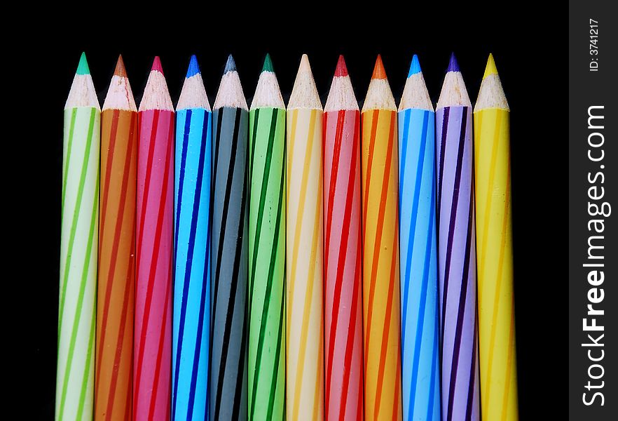 Colored pencils colours on the black background