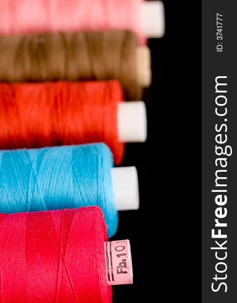 Spools of colorful thread in a row. Spools of colorful thread in a row