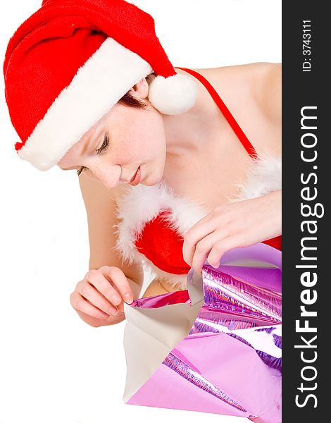 Beautiful girl dressed in a christmas lingerie set unwrapping a gift box With clipping path for your convenience. Beautiful girl dressed in a christmas lingerie set unwrapping a gift box With clipping path for your convenience