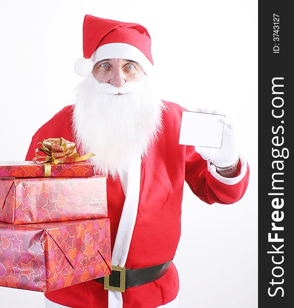 Santa holding a small blank white card and pile gifts. Santa holding a small blank white card and pile gifts.