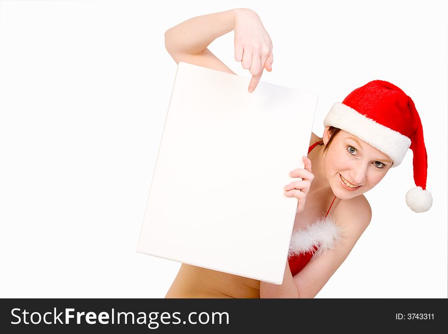 Beautiful girl in christmas bikini and with christmas hat is holding up a white sign for copy space. With background clipping path for your convenience. Beautiful girl in christmas bikini and with christmas hat is holding up a white sign for copy space. With background clipping path for your convenience