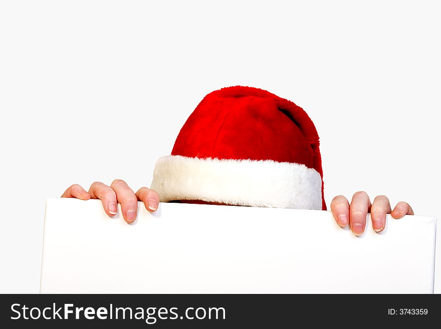 Beautiful girl in christmas bikini and with christmas hat is holding up a white sign for copy space. With background clipping path for your convenience. Beautiful girl in christmas bikini and with christmas hat is holding up a white sign for copy space. With background clipping path for your convenience