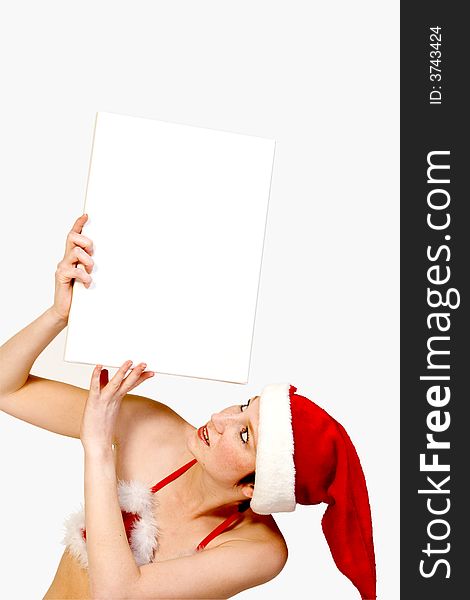 Beautiful girl in christmas bikini and with christmas hat is holding up a white sign for copy space. With background clipping path for your convenience. Beautiful girl in christmas bikini and with christmas hat is holding up a white sign for copy space. With background clipping path for your convenience
