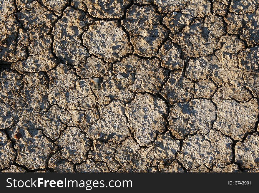 Dry barren cracked earth in drought closeup. Dry barren cracked earth in drought closeup