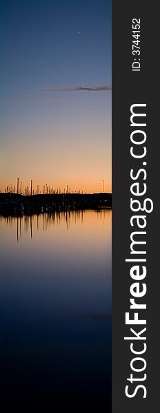 Boats In Harbor At Sunset With Bright Star