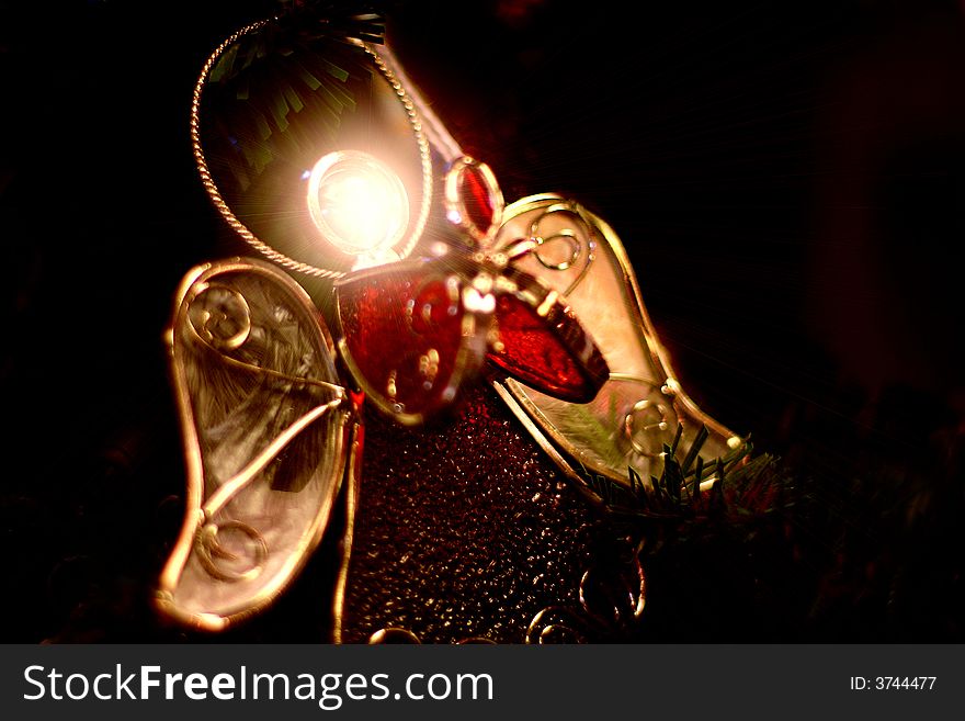 Christmas ornament of an angel holding her hands together.