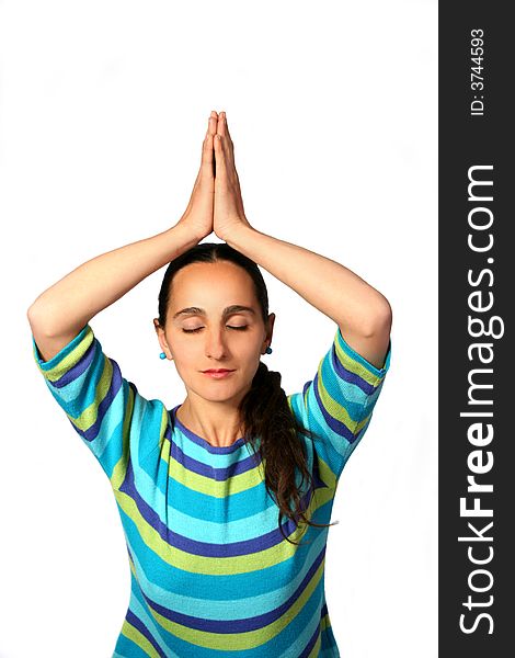 Meditating woman with hands up and eyes closed.