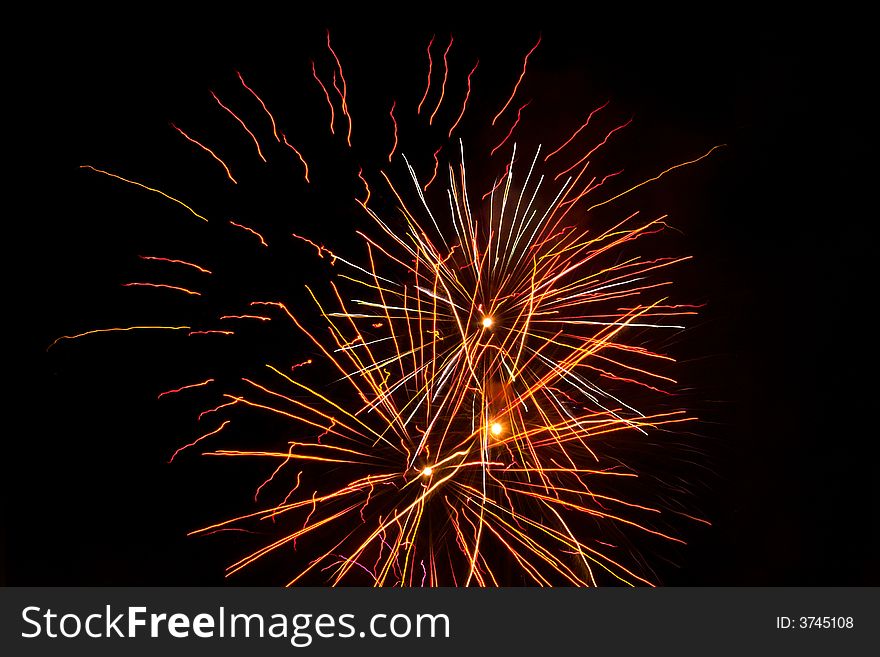 Red, white, fireworks over dark sky