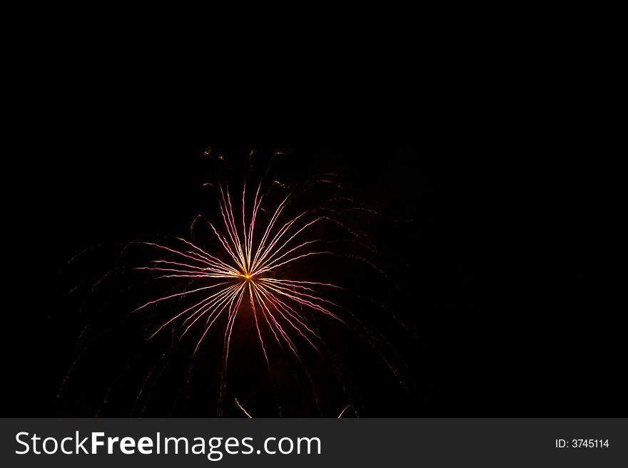 Red, white, fireworks over dark sky