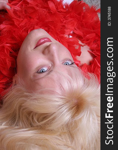 Portrait of a young attractive girl with red feathers. Portrait of a young attractive girl with red feathers