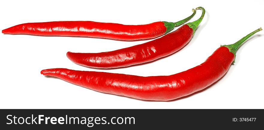 3 isolated red chili peppers against white. 3 isolated red chili peppers against white