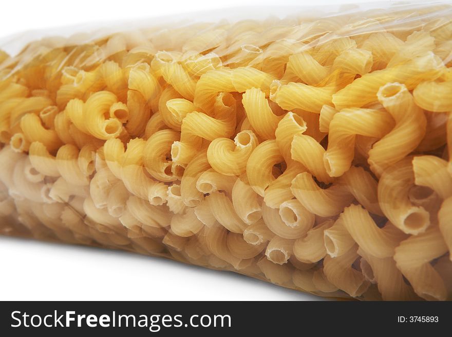 Beautiful macaroni in cellophane packing on a white background