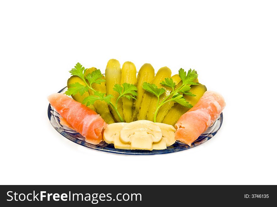 Cucumbers, fish and mushrooms with greenery  on a white background