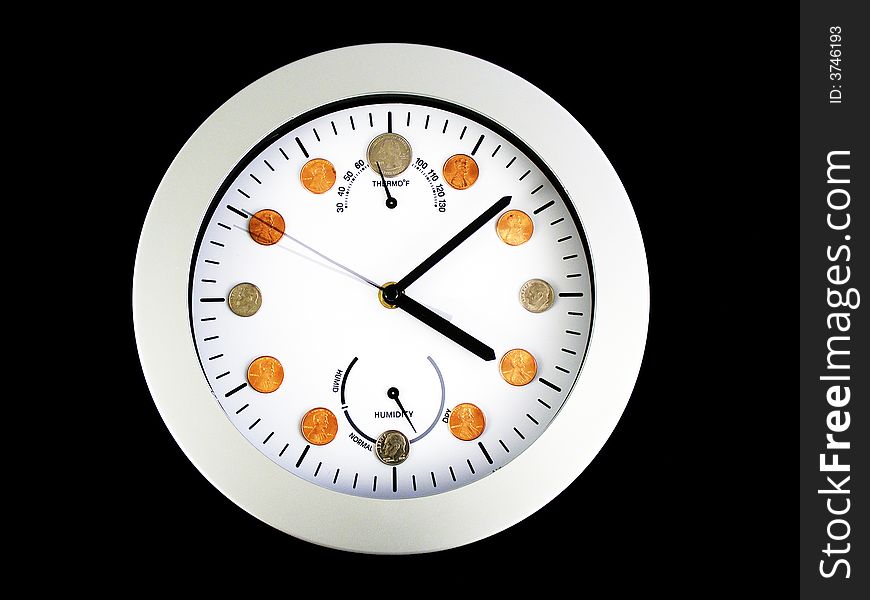 A clock with coins in place of numbers. A clock with coins in place of numbers.