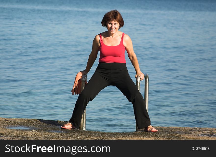 Senior woman making poses on the beach. Senior woman making poses on the beach