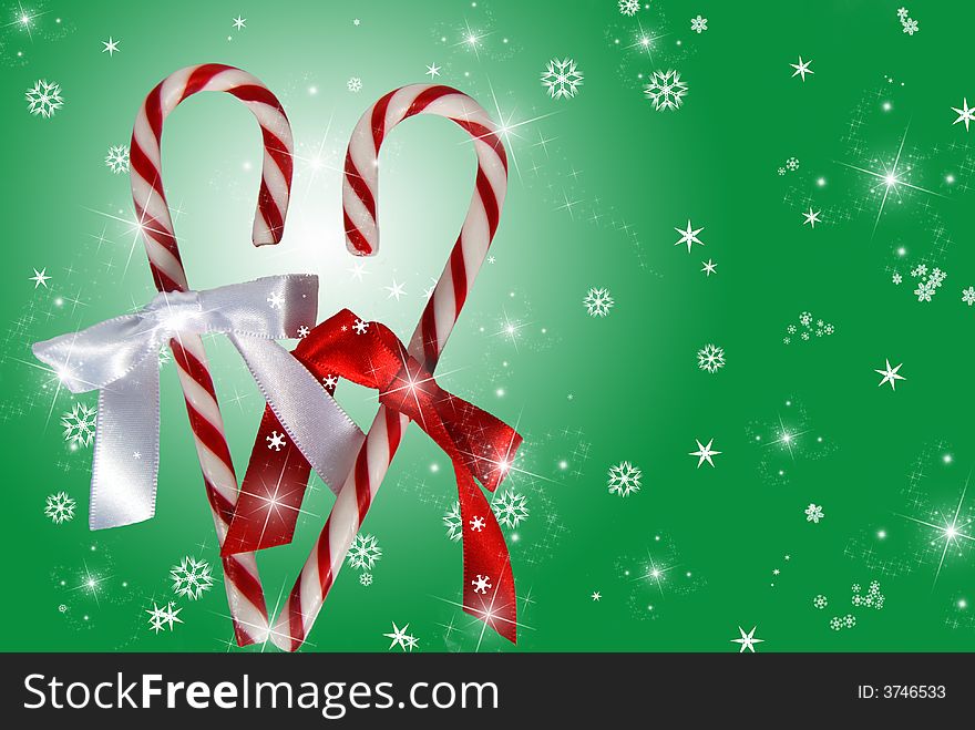 Pair of candy canes on a holiday winter background. Pair of candy canes on a holiday winter background.
