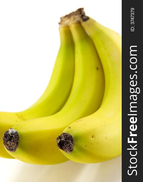 A hand of ripe bananas on white background.