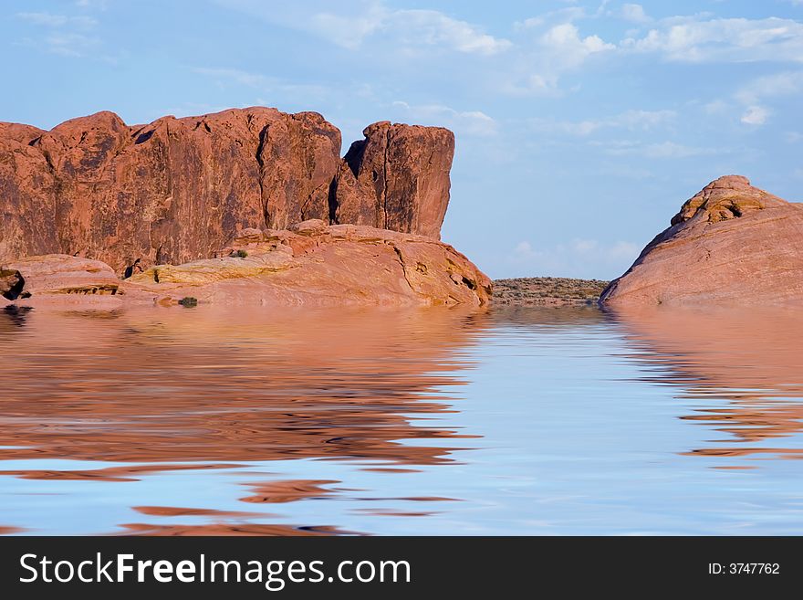 Red cliffs, blue sky and a blue lake. Red cliffs, blue sky and a blue lake.