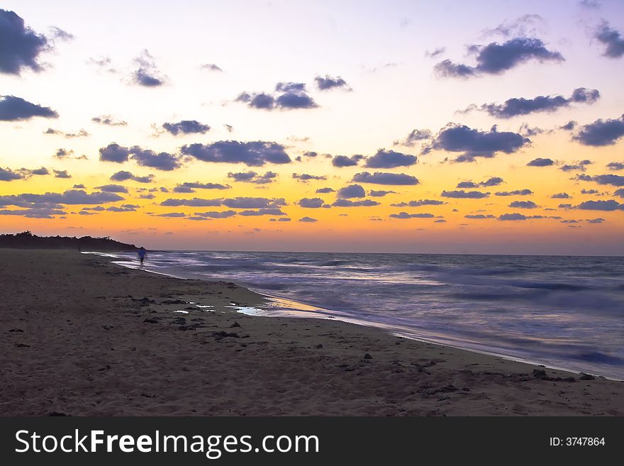 Beach sunset orange glow ocean and waves