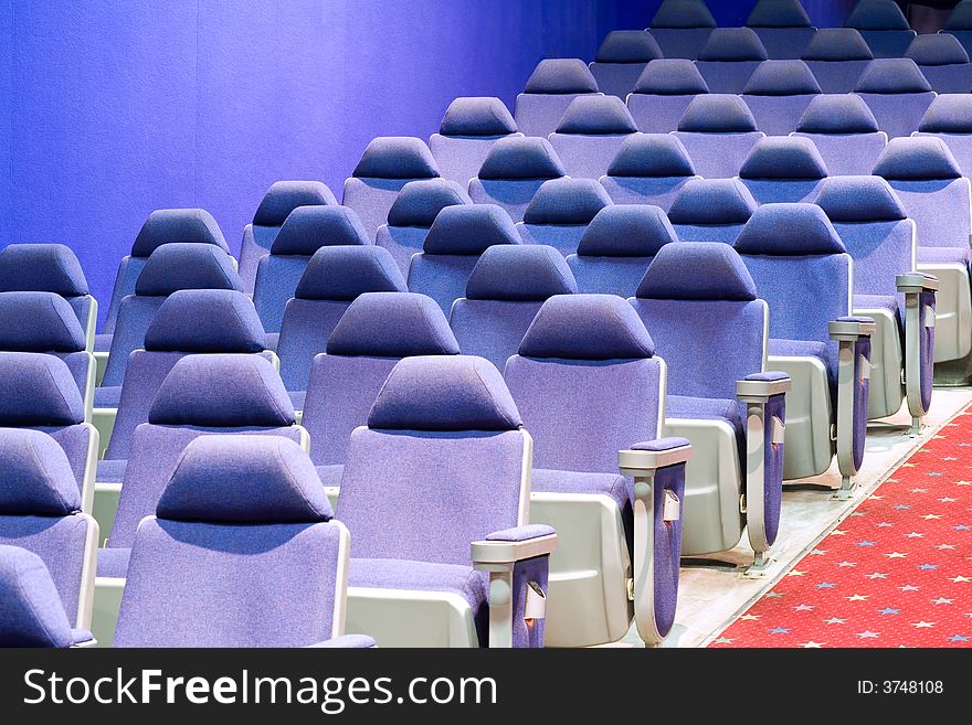 Empty cinema auditorium with blue chairs