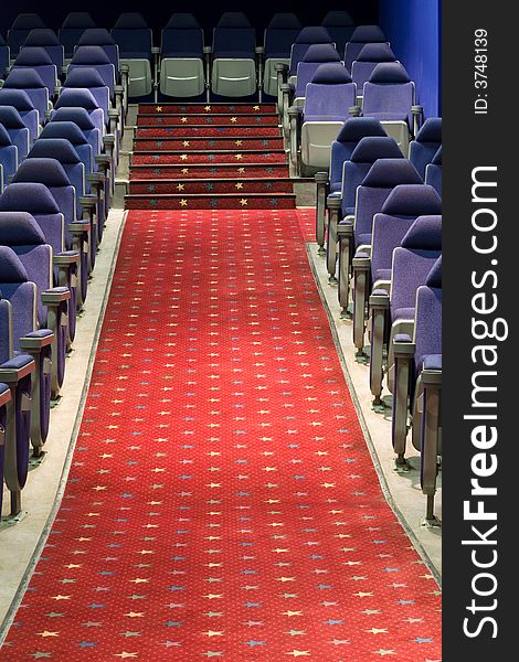 Empty cinema auditorium with blue chairs