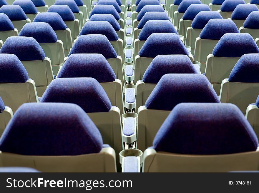 Empty cinema auditorium with blue chairs