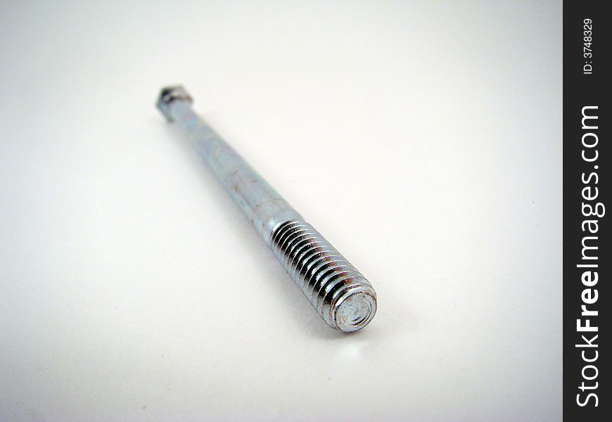 A bolt lying at an angle threaded end toward the camera.