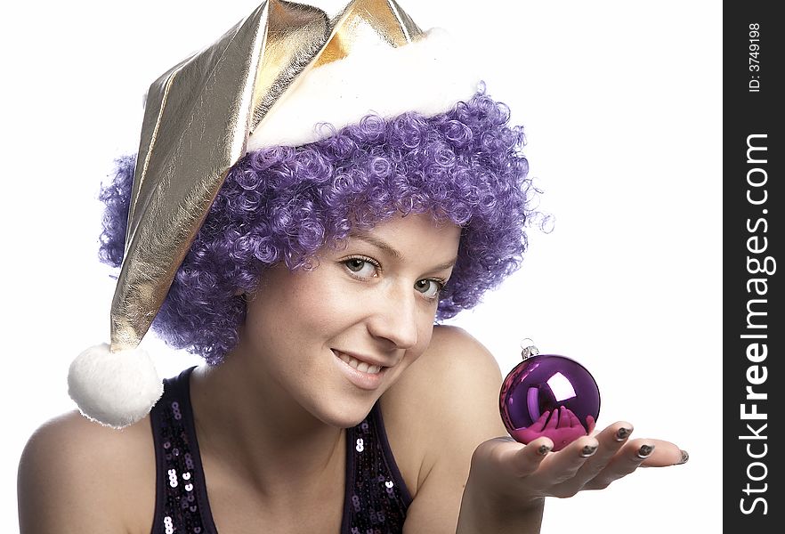 Girl in santa's hat and purple wig with christmas ball. Girl in santa's hat and purple wig with christmas ball