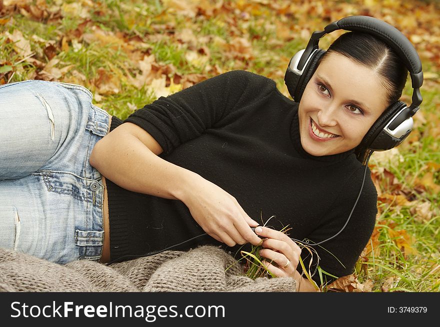 The girl with headphones in park