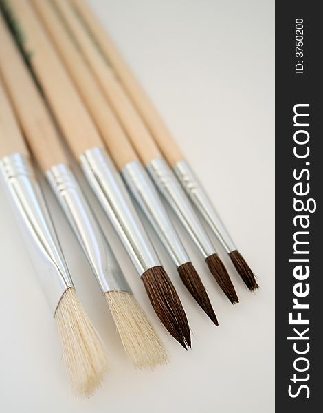 Close - up of paint brushes isolated on white.