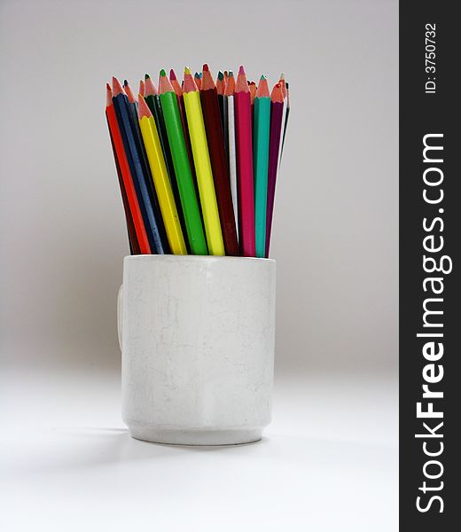 Colored pencils standing in a jug. Colored pencils standing in a jug.