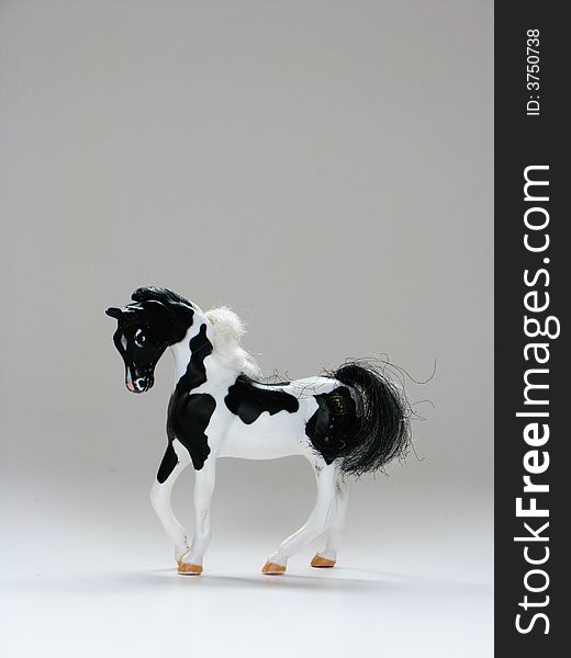 A plastic toy horse on a white background. A plastic toy horse on a white background