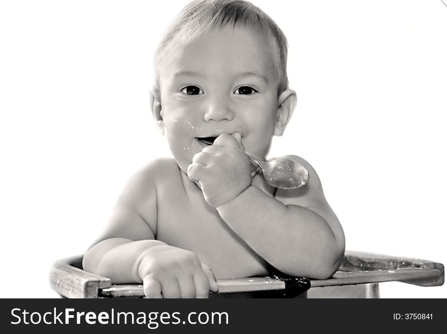 Baby boy eating himself over white