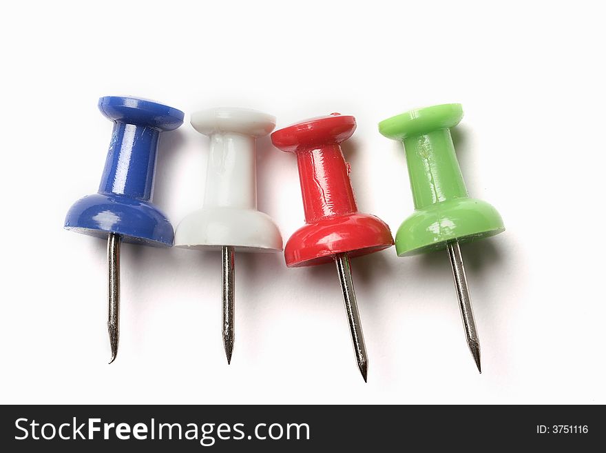 Colored push pins isolated on white background