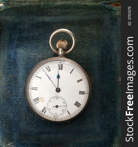 Antique watch on a distressed velvet background. Antique watch on a distressed velvet background