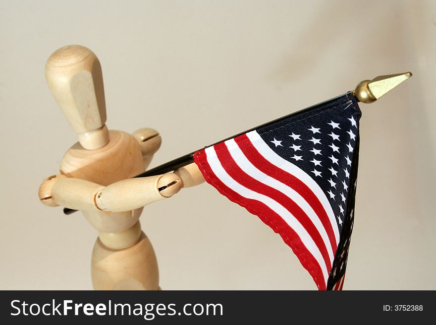 Wooden model holding USA flag anf marching