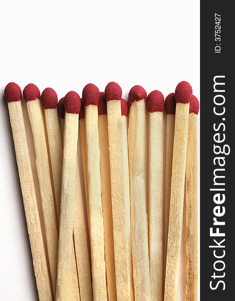 Wooden Matchsticks with red sulfur tips isolated on white background