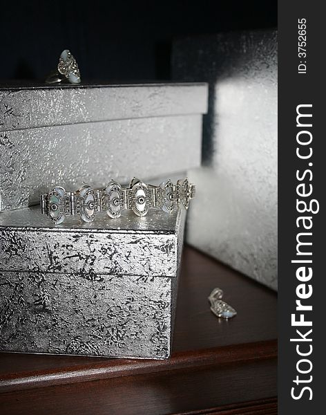 Three silver gift boxes with silver jewelry