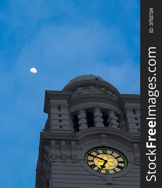 Moon at its zenith above a colonial style clock tower just before sun up. Moon at its zenith above a colonial style clock tower just before sun up