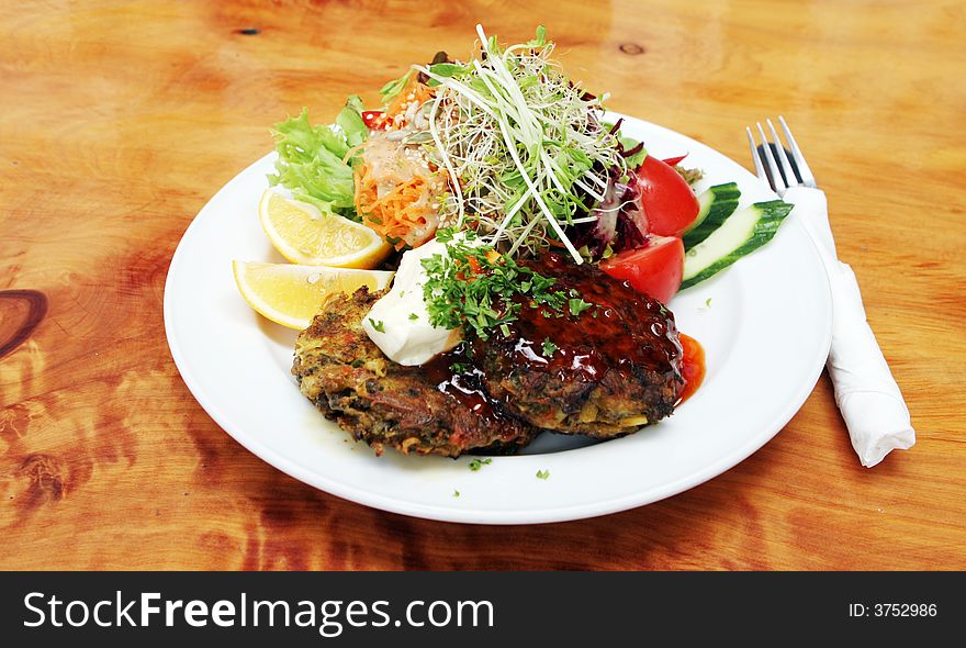 Fresh mussel fritters and salad with sour cream.