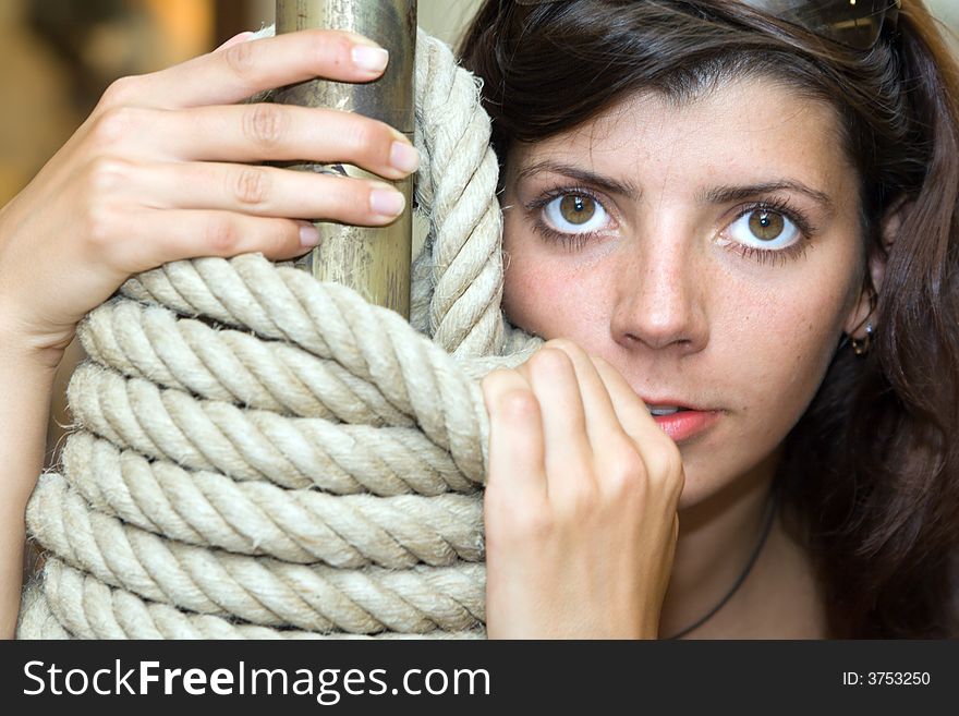 Young woman with big beautiful eyes and rope.