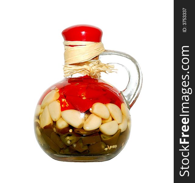 Decorative bottle with sealed vegetables isolated over a white background