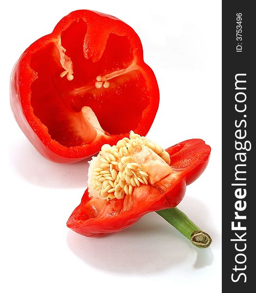 Isolated big nice slit red paprika with seeds against white. Isolated big nice slit red paprika with seeds against white