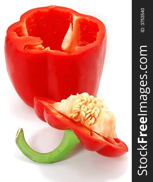 Isolated big nice slit red paprika with seed against white. Isolated big nice slit red paprika with seed against white