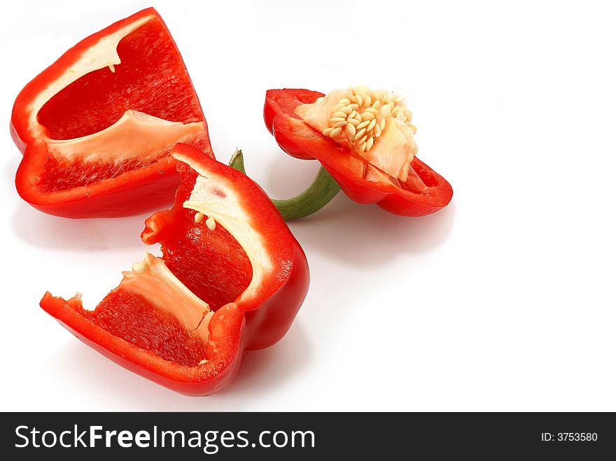 Isolated slit red paprika with seed against white. Isolated slit red paprika with seed against white