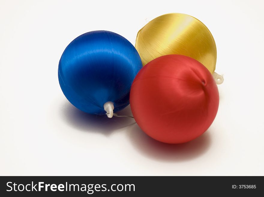 Three assorted colored Christmas Balls isolated against a white background. Three assorted colored Christmas Balls isolated against a white background