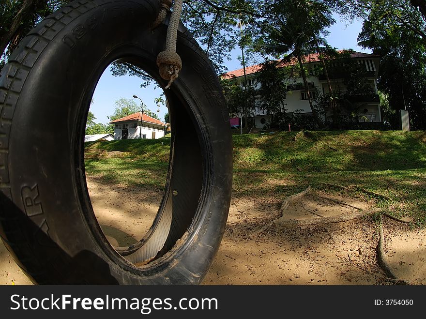 Tyre swing and old house surround by the trees