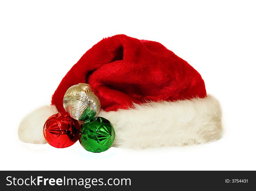 Santa hat and three ornaments isolated on white background. Santa hat and three ornaments isolated on white background