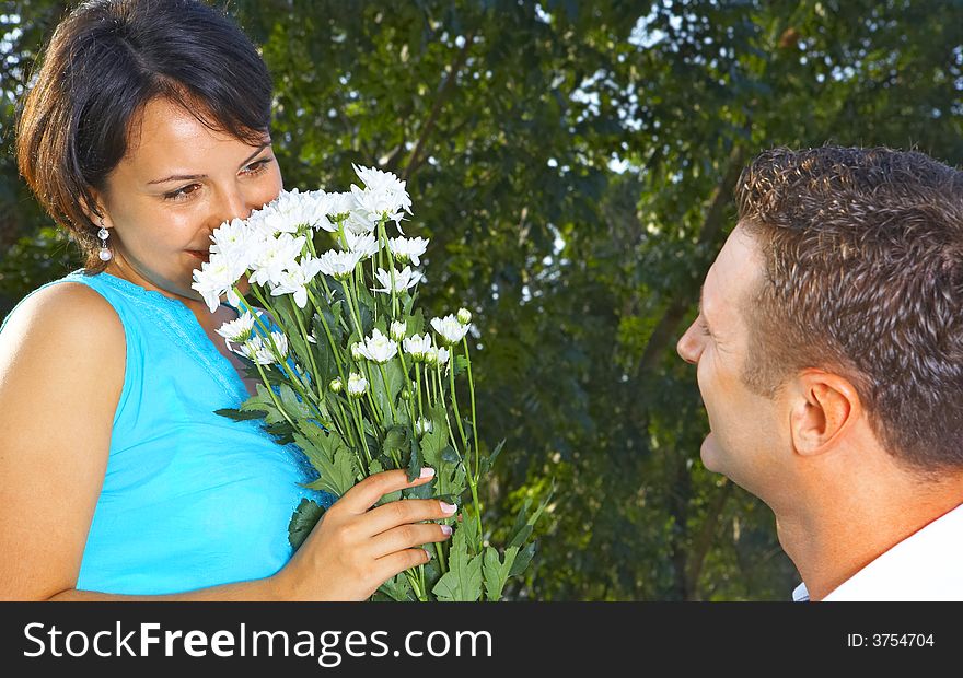 A portrait of attractive couple in summer environment. A portrait of attractive couple in summer environment